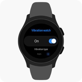 A Galaxy Watch is on a surface while its face shows a menu for turning on vibrations.